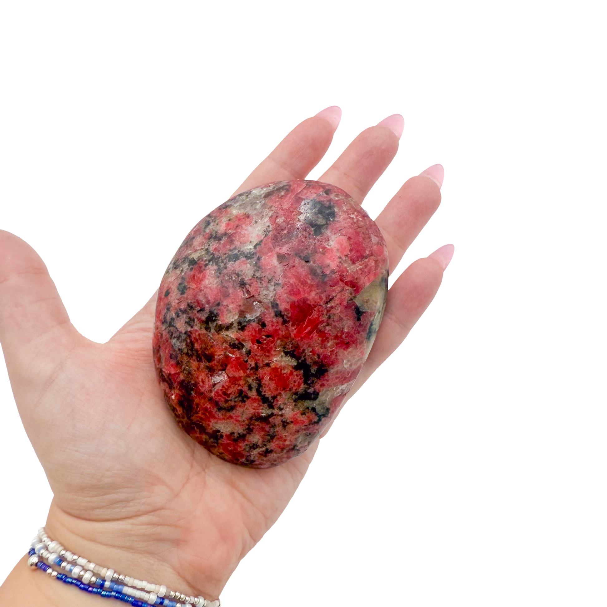 Rhodonite polished free form from Zimbabwe held in hand to show scale
