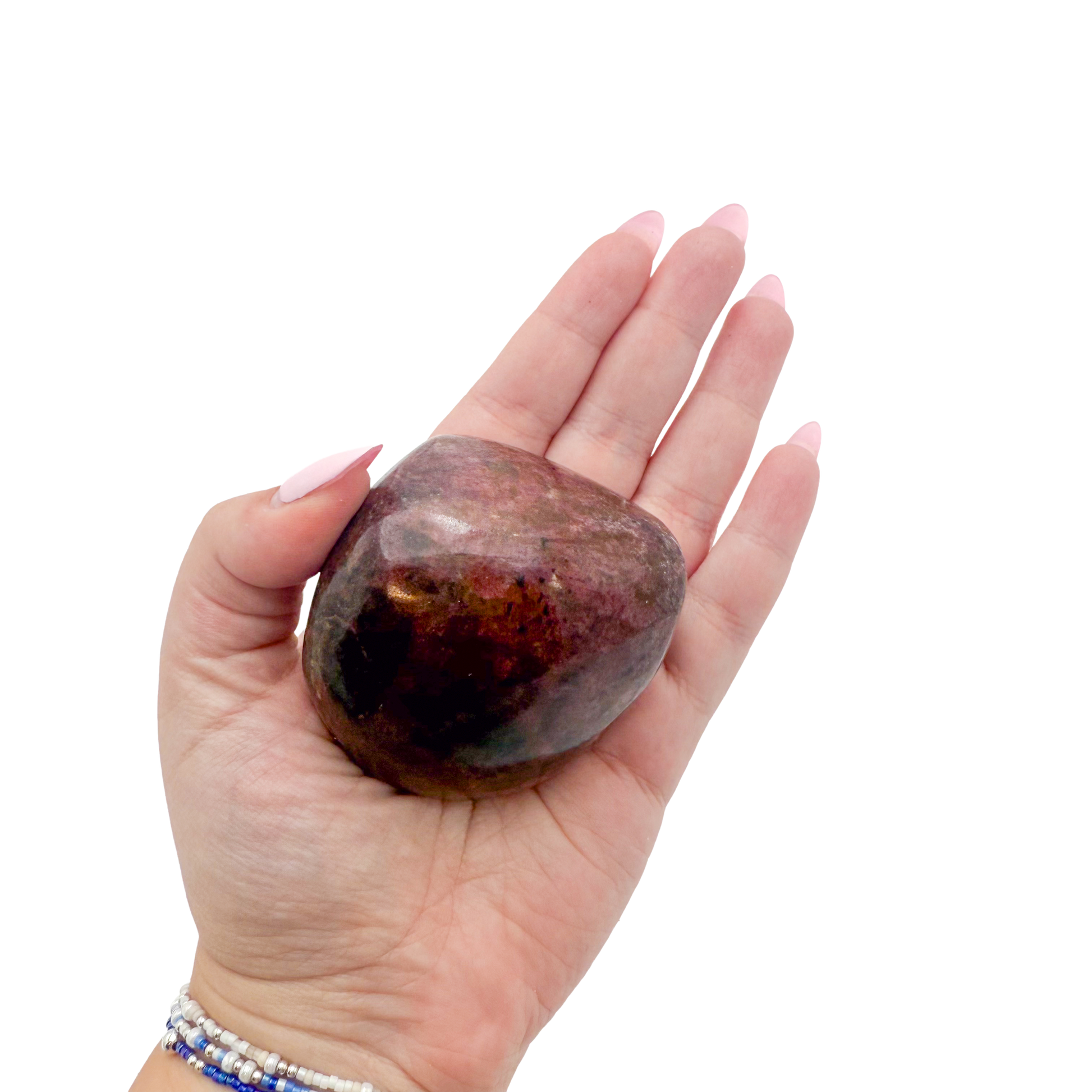 Rhodonite polished free form from Zimbabwe held in hand to show scale