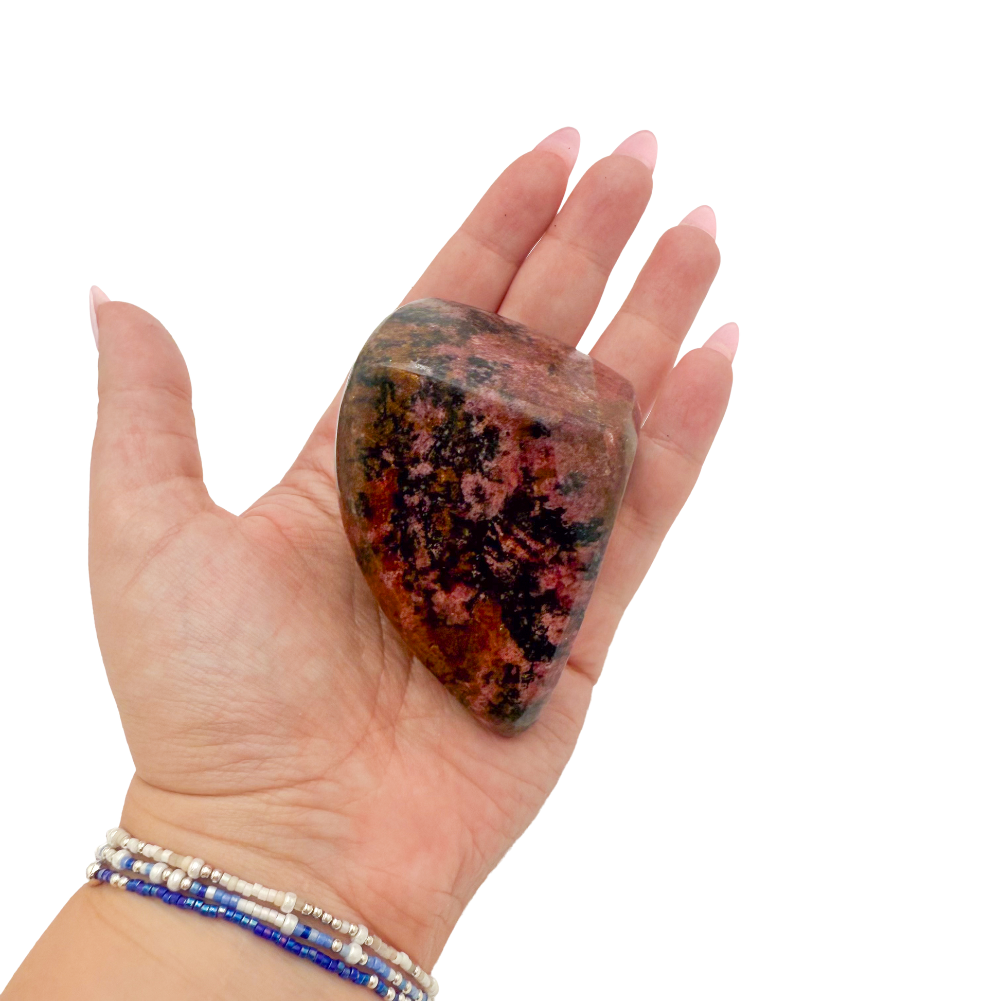 Rhodonite polished free form from Zimbabwe held in hand to show scale