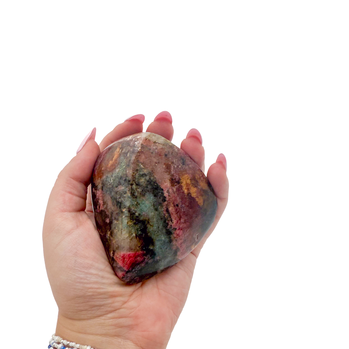 Rhodonite polished free form from Zimbabwe held in hand to show scale