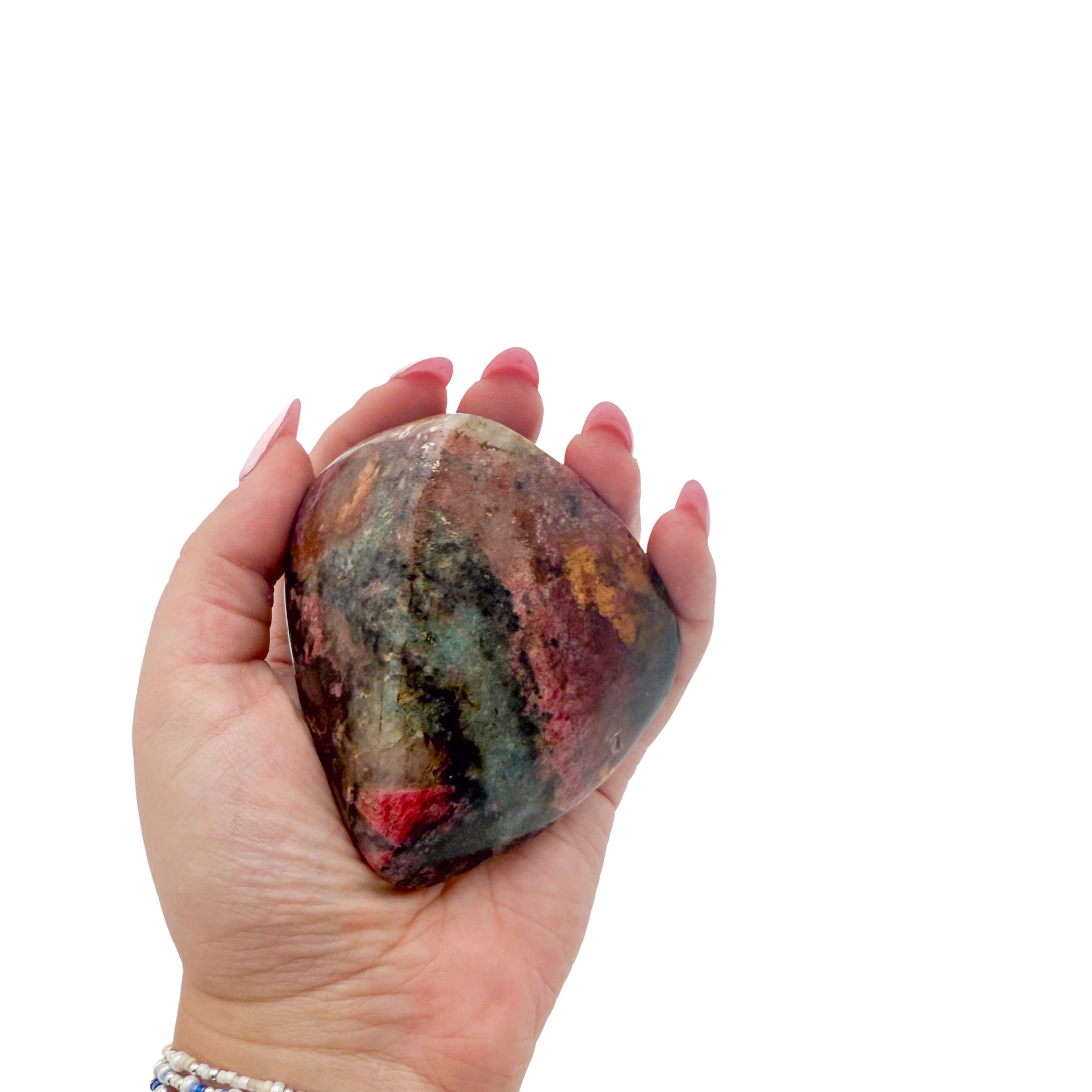 Rhodonite polished free form from Zimbabwe held in hand to show scale