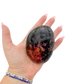 Rhodonite polished free form from Zimbabwe held in hand to show scale