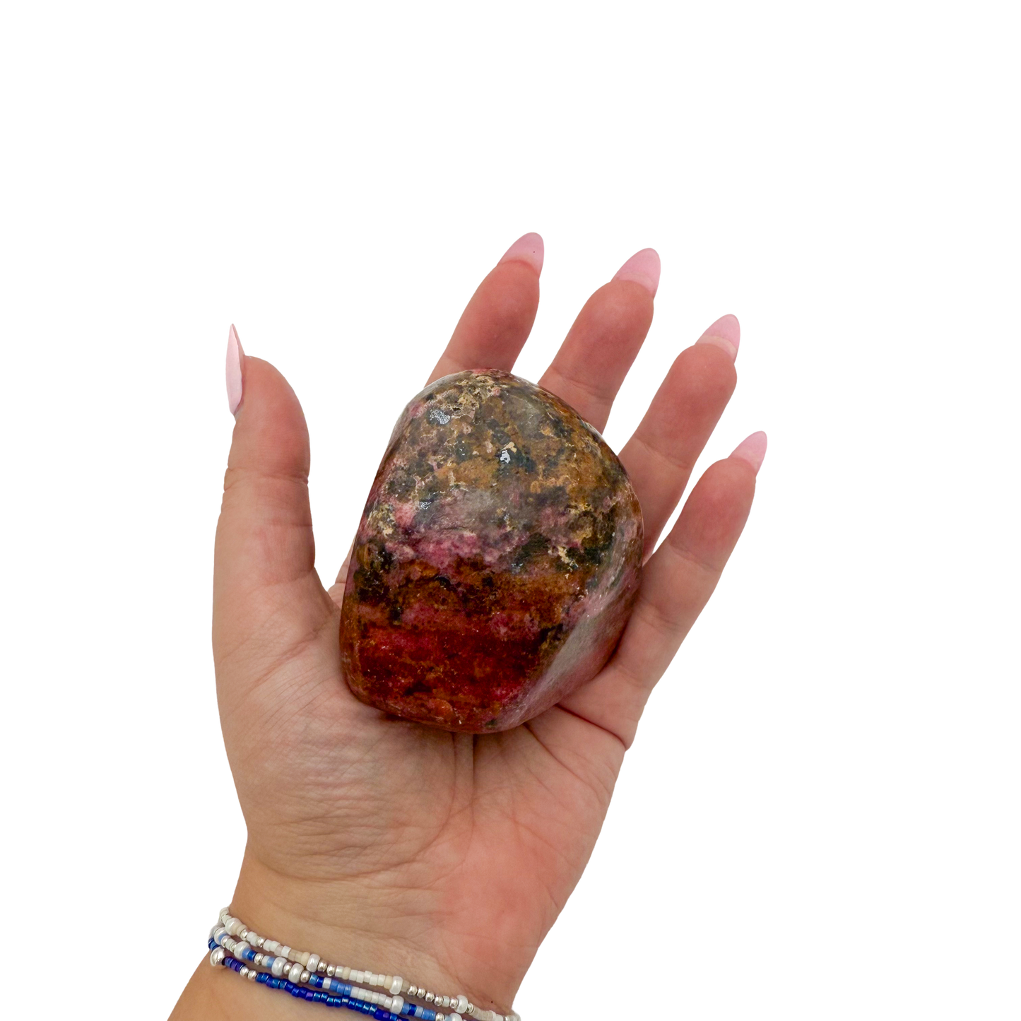 Rhodonite polished free form from Zimbabwe held in hand to show scale