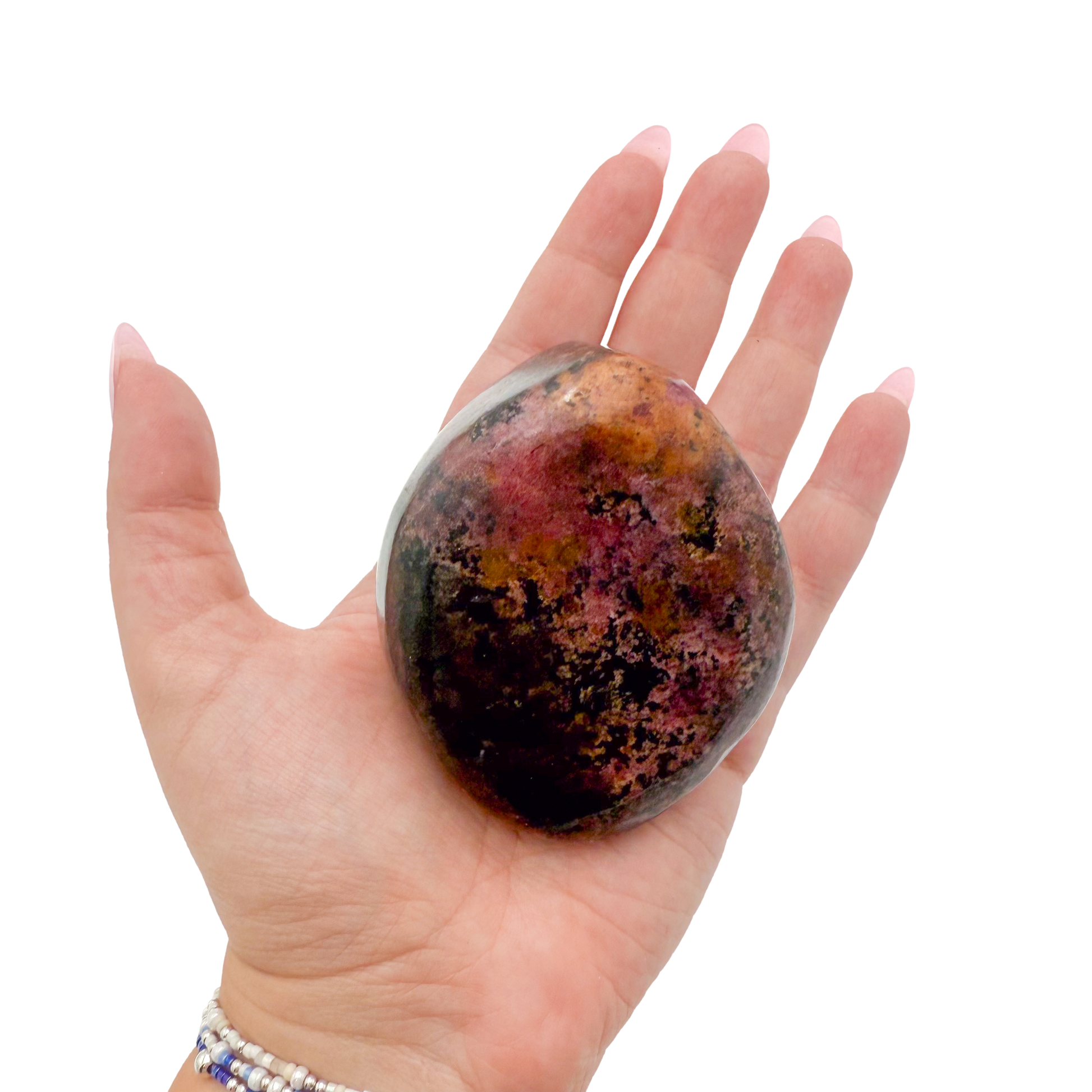 Rhodonite polished free form from Zimbabwe held in hand to show scale