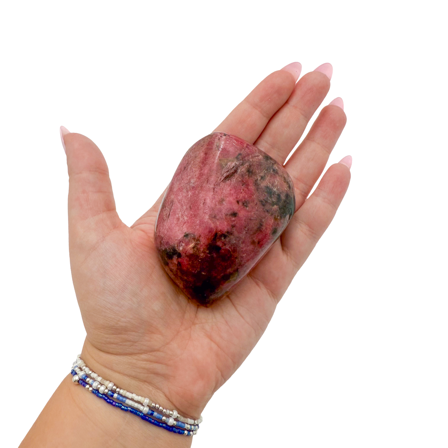Rhodonite polished free form from Zimbabwe held in hand to show scale
