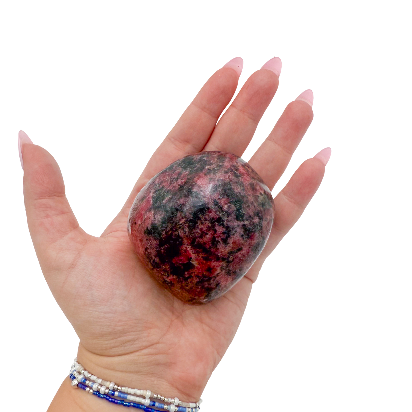 Rhodonite polished free form from Zimbabwe held in hand to show scale