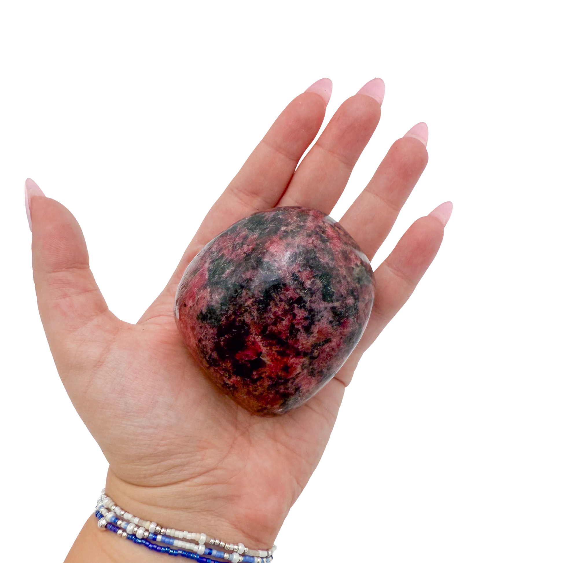 Rhodonite polished free form from Zimbabwe held in hand to show scale