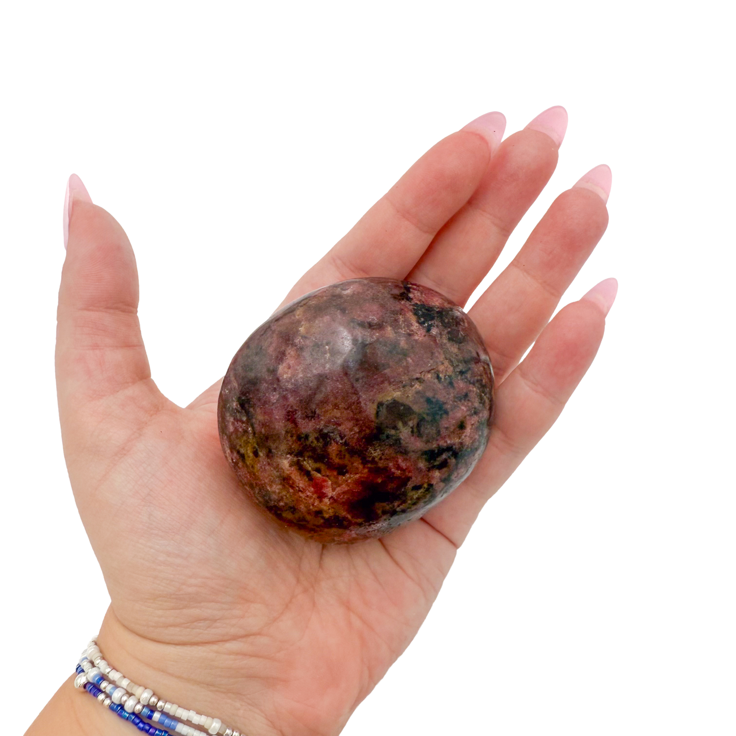 Rhodonite polished free form from Zimbabwe held in hand to show scale