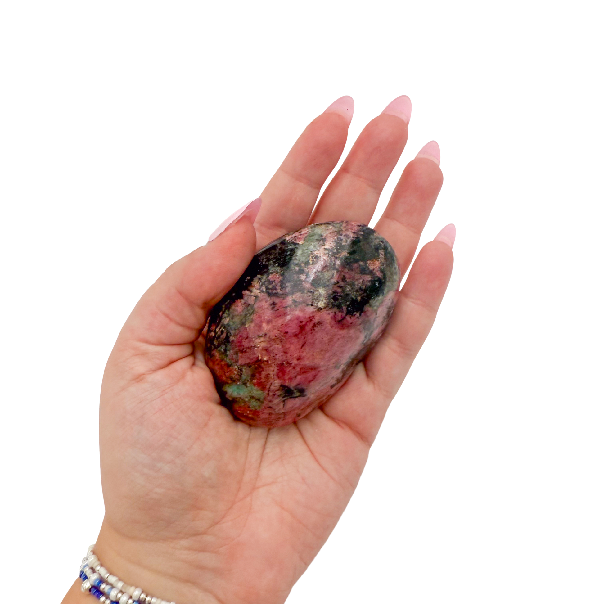 Rhodonite polished free form from Zimbabwe held in hand to show scale