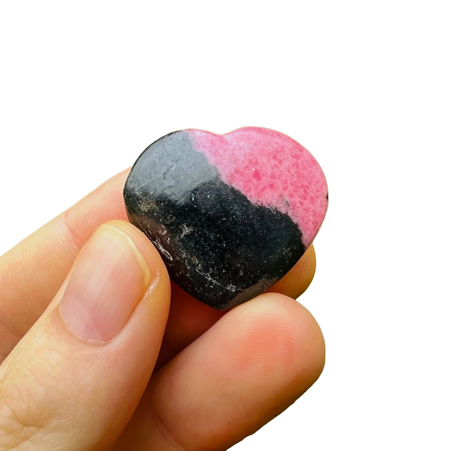 Edge-on view of Rhodonite polished heart, showing translucent edges, hand-selected from Atsimo-Andrefana, Madagascar.