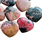 Top-down shot of Rhodonite polished heart, kept near for Emotional Healing, from Atsimo-Andrefana, Madagascar.