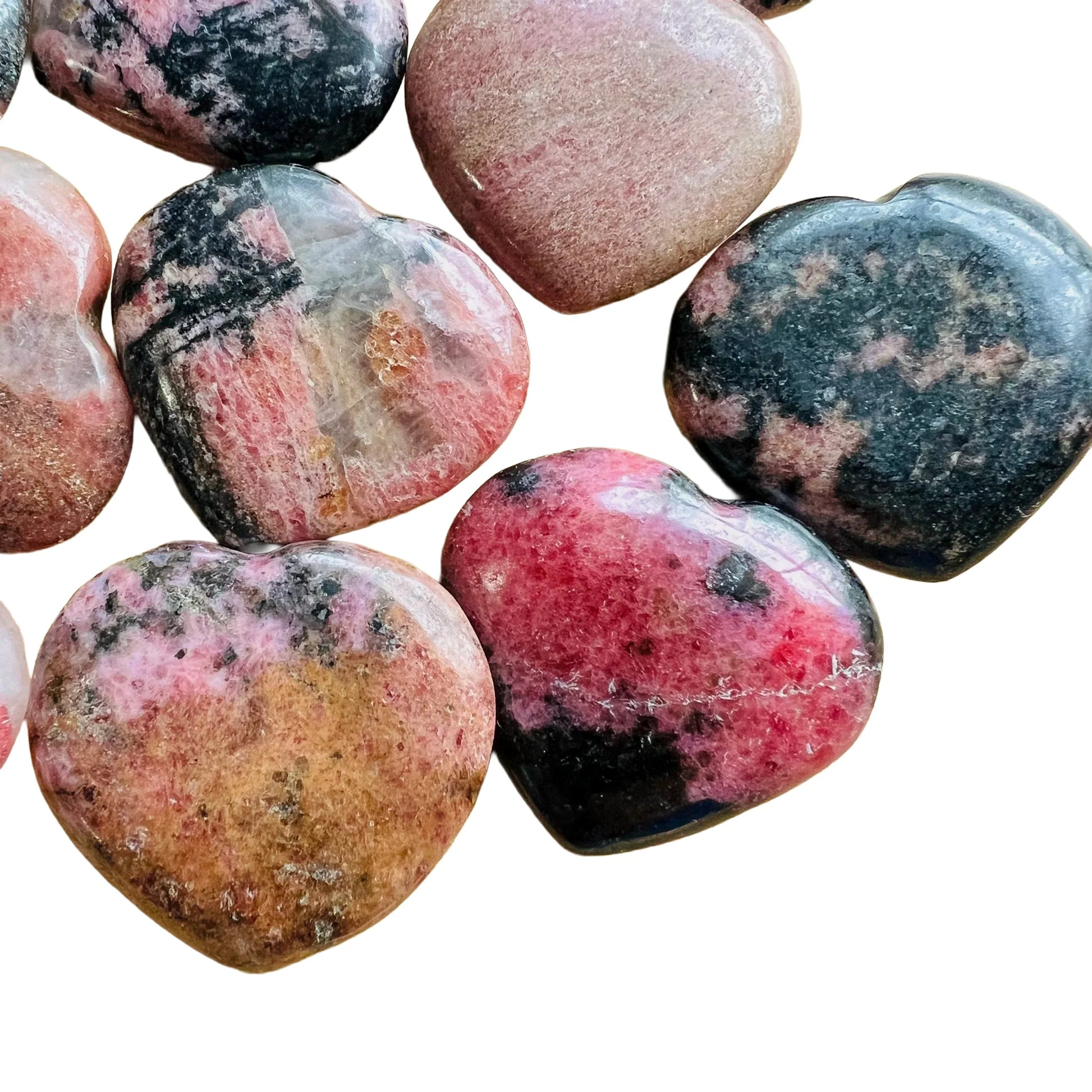 Top-down shot of Rhodonite polished heart, kept near for Emotional Healing, from Atsimo-Andrefana, Madagascar.