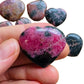 Size comparison with a single Rhodonite polished heart sourced from Madagascar.