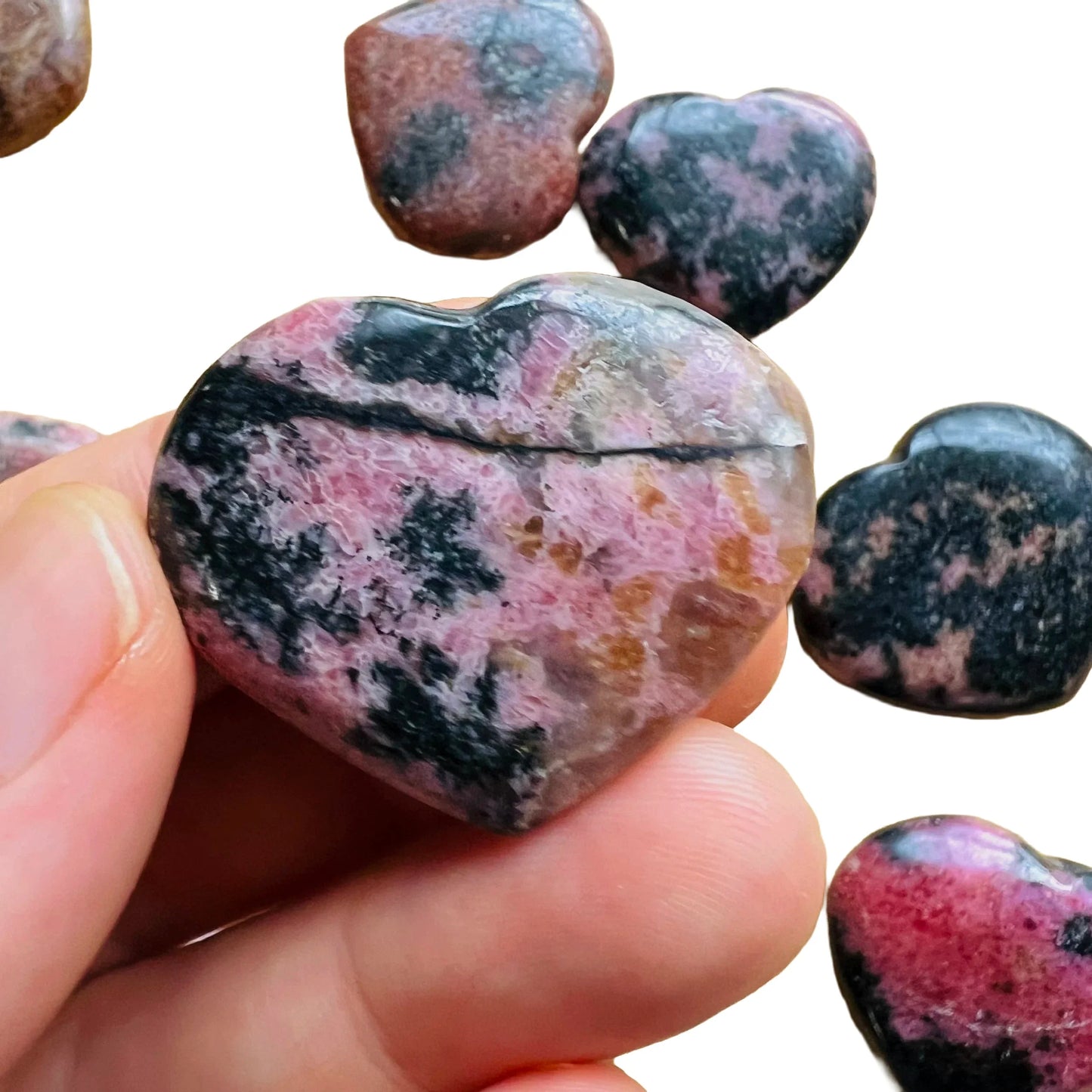 Back view of Grade AA Rhodonite heart showing natural surface