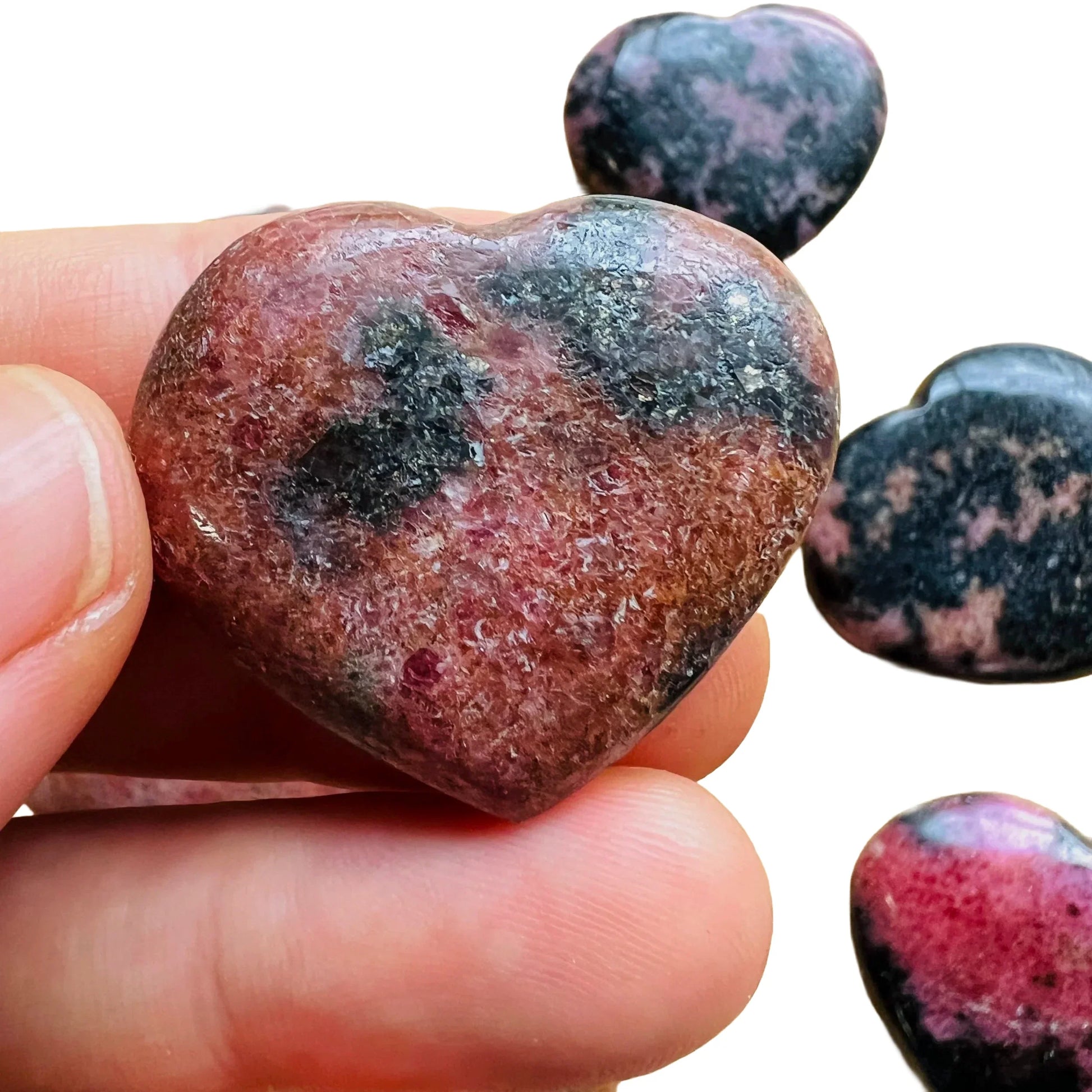 Detail shot of Grade AA Rhodonite heart under natural light