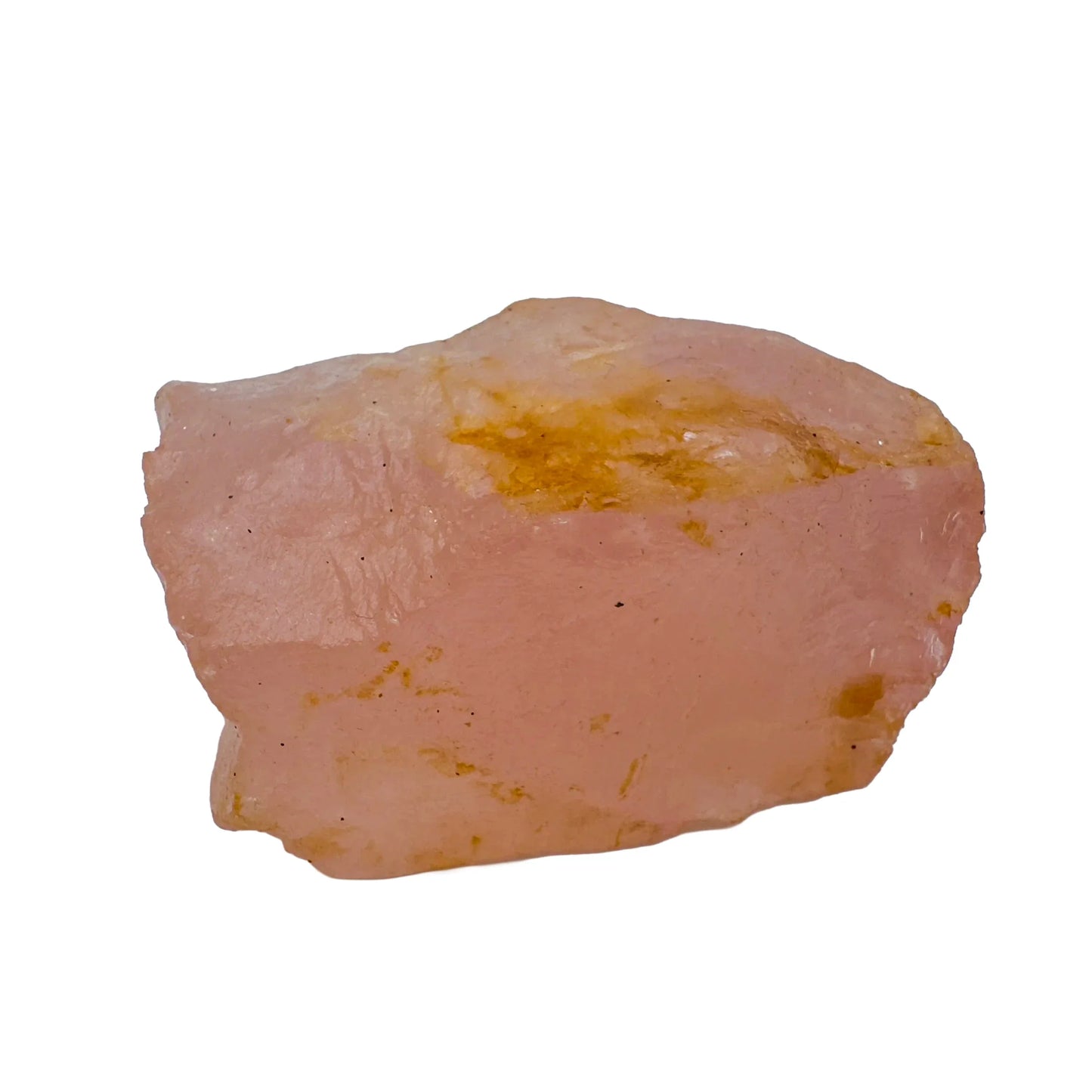 Hand-held view of a Rose Quartz specimen held against natural backdrop.