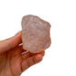 Held in hand is a Rose Quartz specimen, from Alaotra-Mangoro, Madagascar, captured in soft, even lighting.