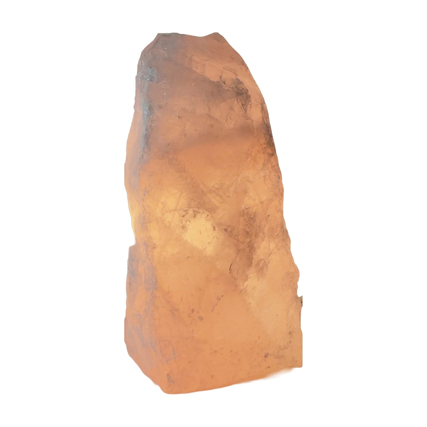 Rose quartz crystal lamp lit, soft warm pink glow through the stone