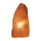 Rose quartz crystal lamp lit, warm illumination, further view