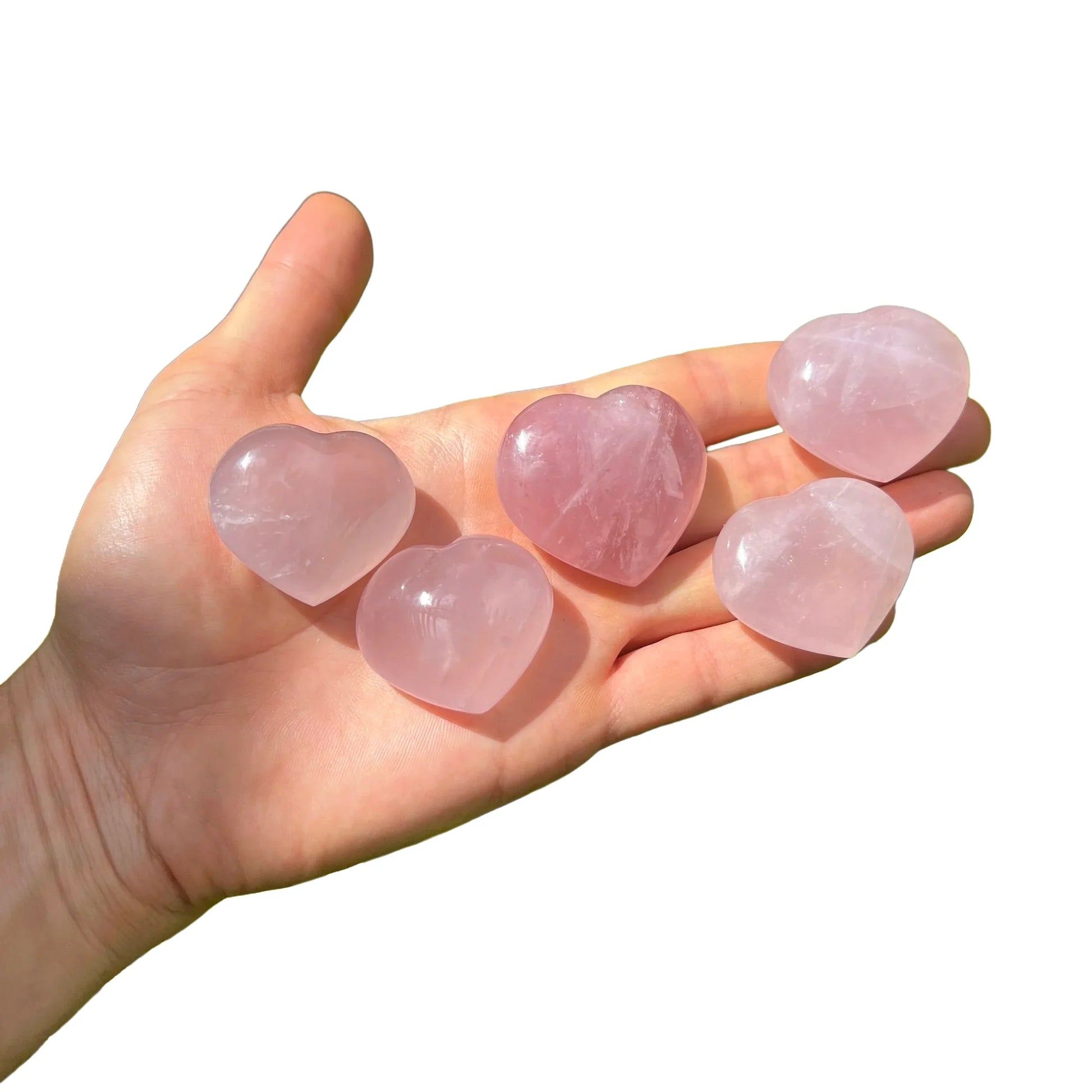 Edge view of pink Rose Quartz polished heart, showing color depth, Madagascar-sourced.