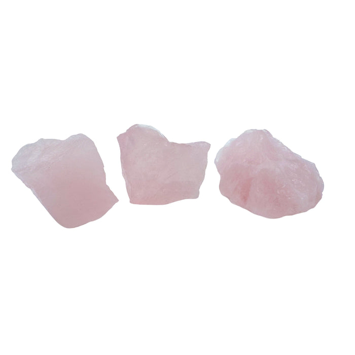 Three AA grade Rose Quartz chunks from Minas Gerais, Brazil, lined up on white to show the 1 to 2 inch size and soft blush color.