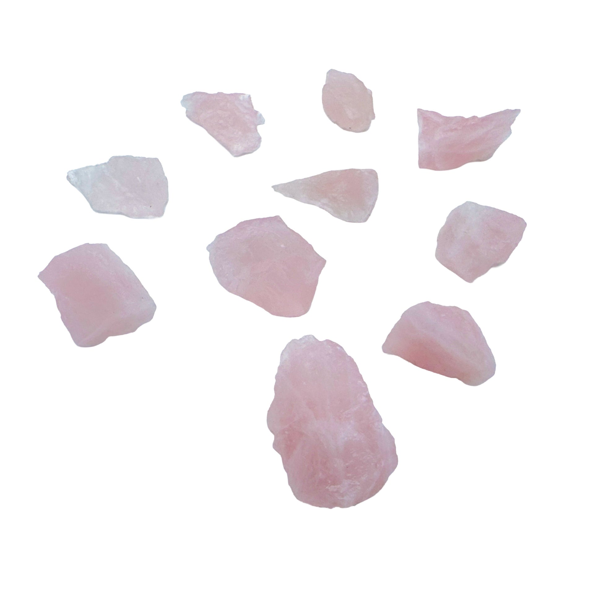 Rose Quartz pieces spanning the color range in a single lot, from milky near-white through to deeper rose pink.
