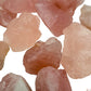 Lifestyle view of one Rose Quartz raw stone for scale, from Namibia.