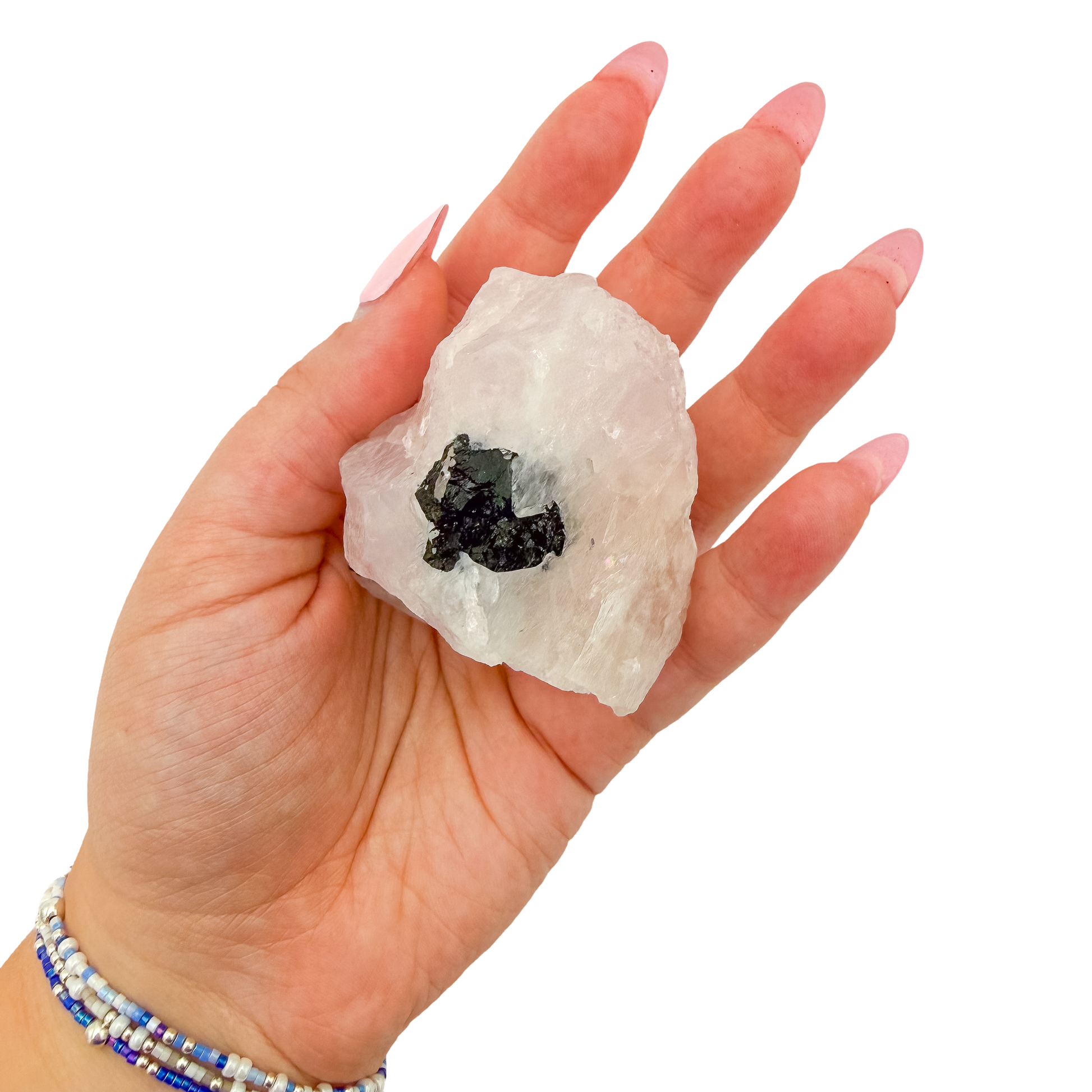 The blocky pink form held in a hand, showing the scale of this 2.47 inch specimen