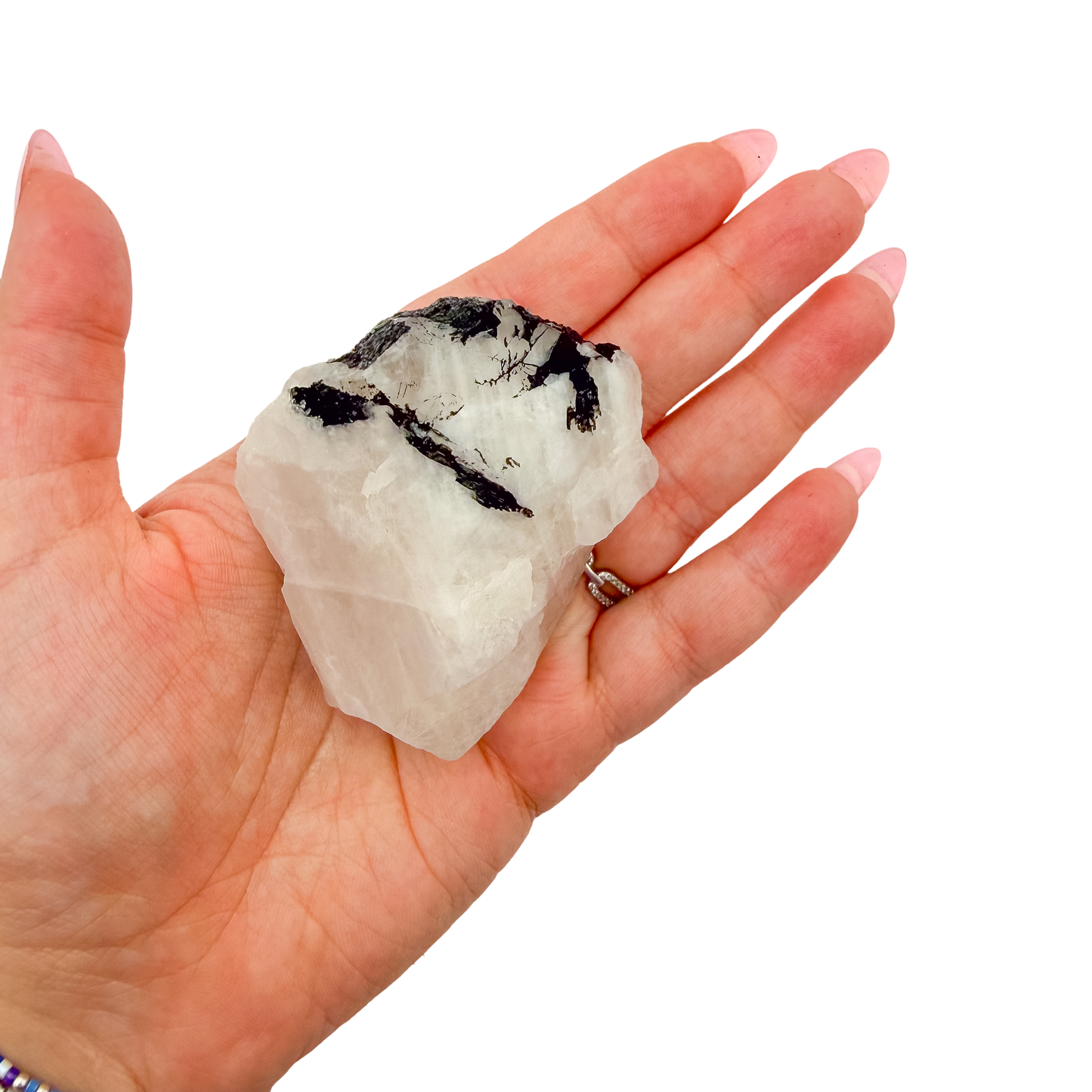 A 128 g rose quartz with tourmaline, the broad pink face, resting in an open palm