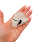 The even pink body held in a hand, showing the scale of this 2.36 inch specimen