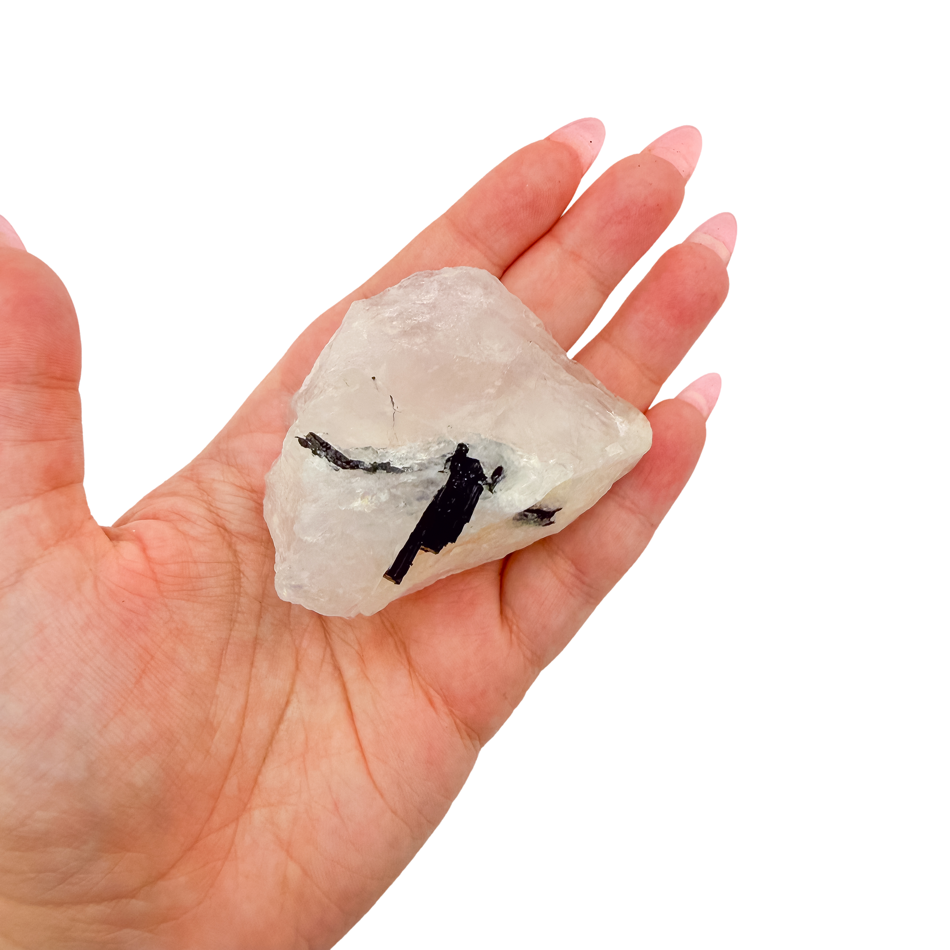 The even pink body held in a hand, showing the scale of this 2.36 inch specimen