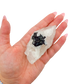 A 163 g rose quartz with tourmaline, the tapered pink piece, resting in an open palm