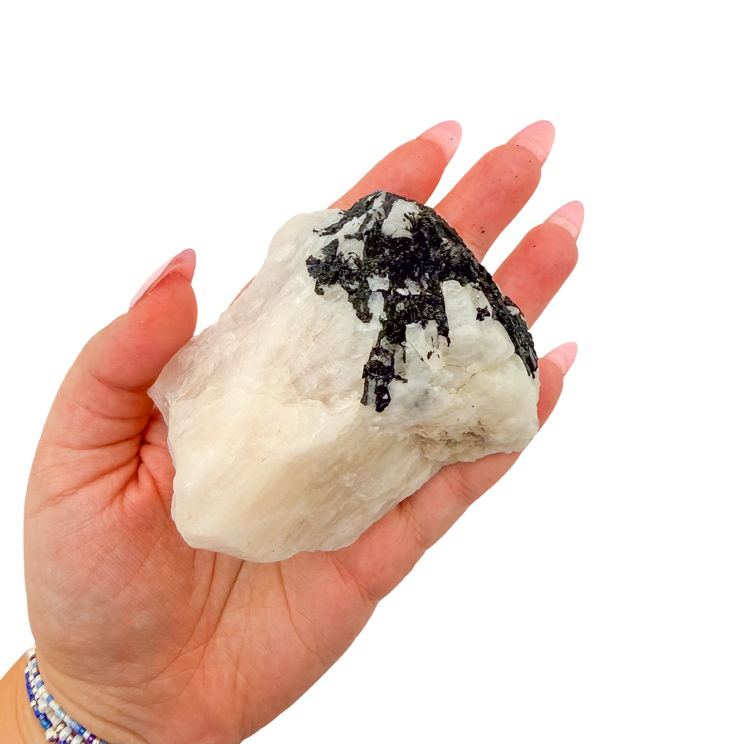 A 276 g rose quartz with tourmaline, the broad pink slab, resting in an open palm