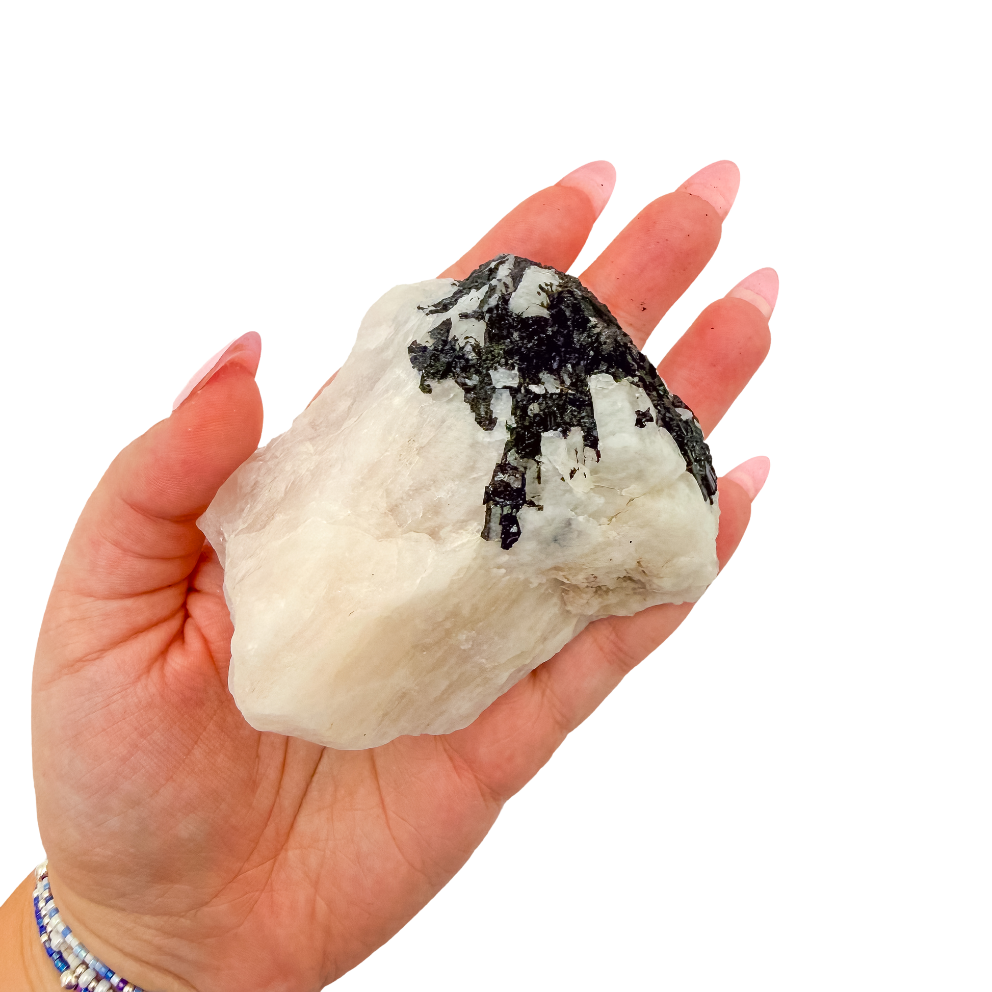 A 276 g rose quartz with tourmaline, the broad pink slab, resting in an open palm