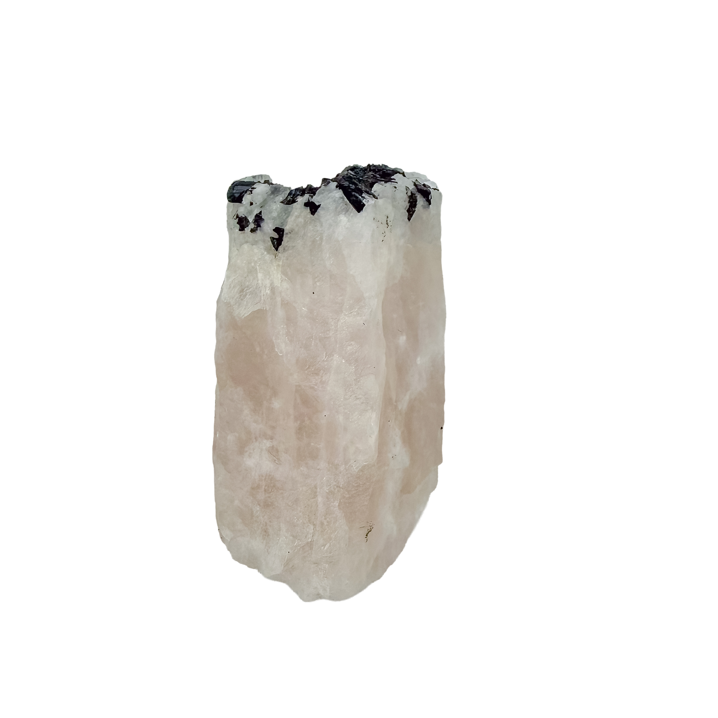 Detail of jet-black crystal against the pale pink of the large pink block