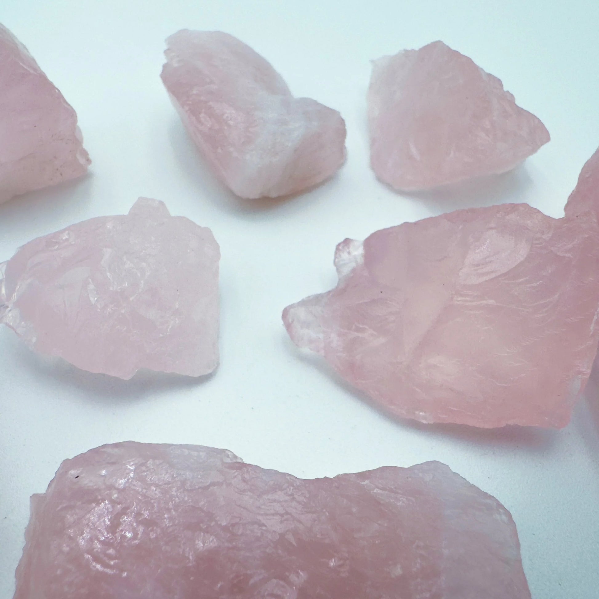 Grade aa rose quartz raw held in hand for size reference