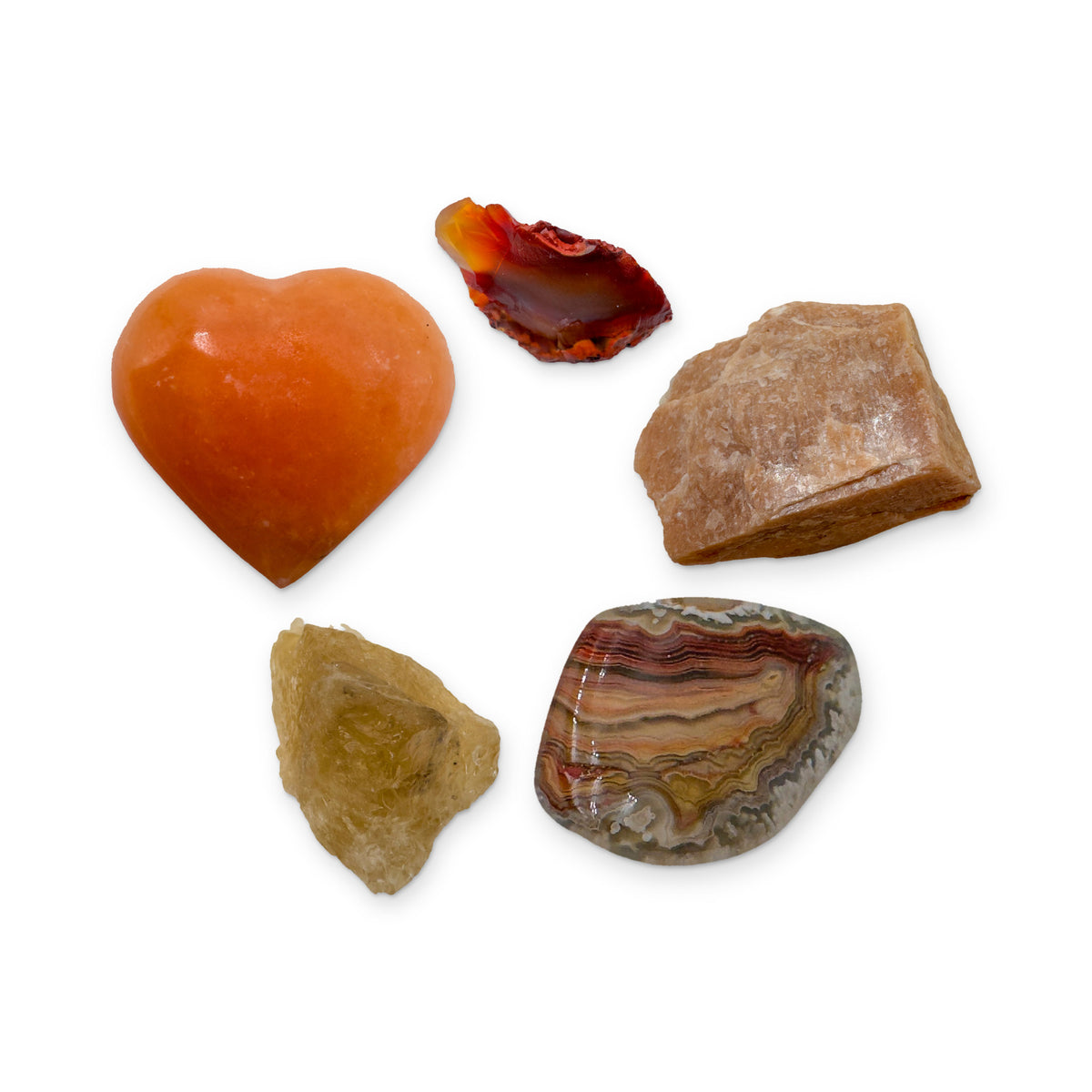 Sacral Chakra Crystal Kit: orange calcite heart, carnelian, peach moonstone, crazy lace agate and natural citrine, shown together on white