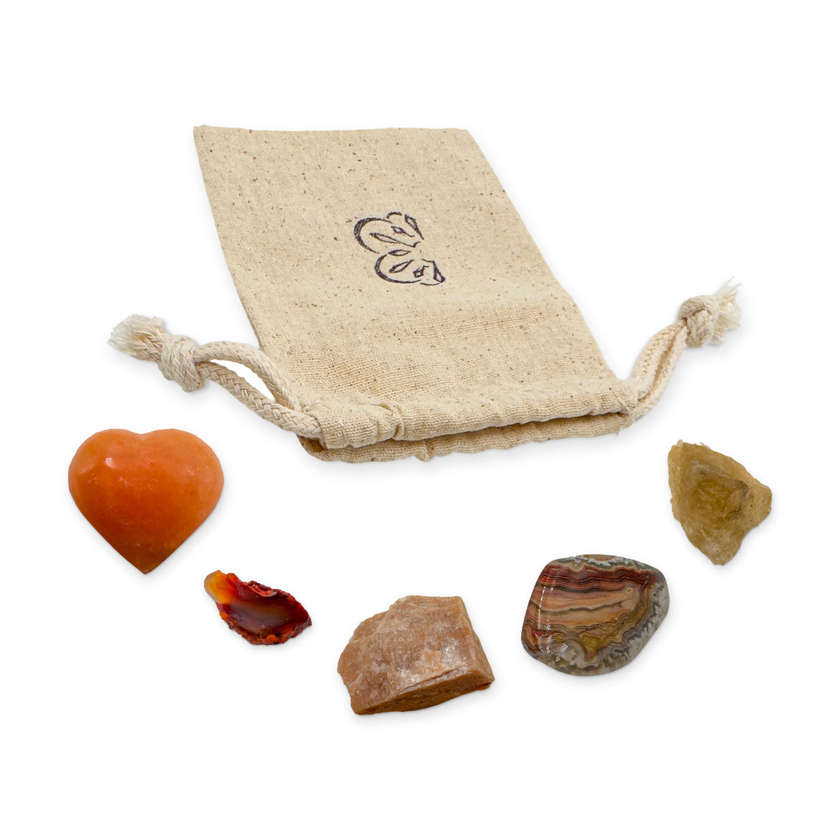 Sacral Chakra Crystal Kit: orange calcite heart, carnelian, peach moonstone, crazy lace agate and natural citrine, arranged with the reusable cotton bag they come in, on white