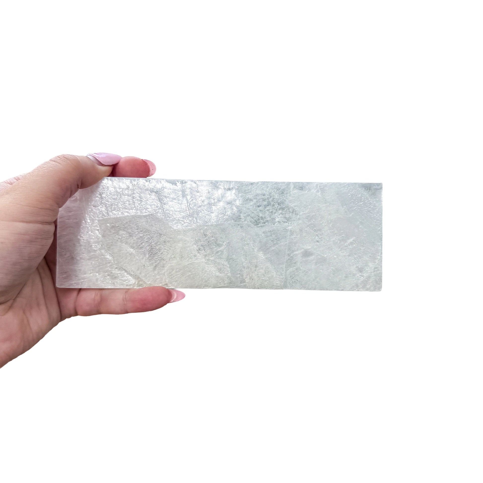 A Selenite polished stick held up against daylight, AAA grade, from New Mexico