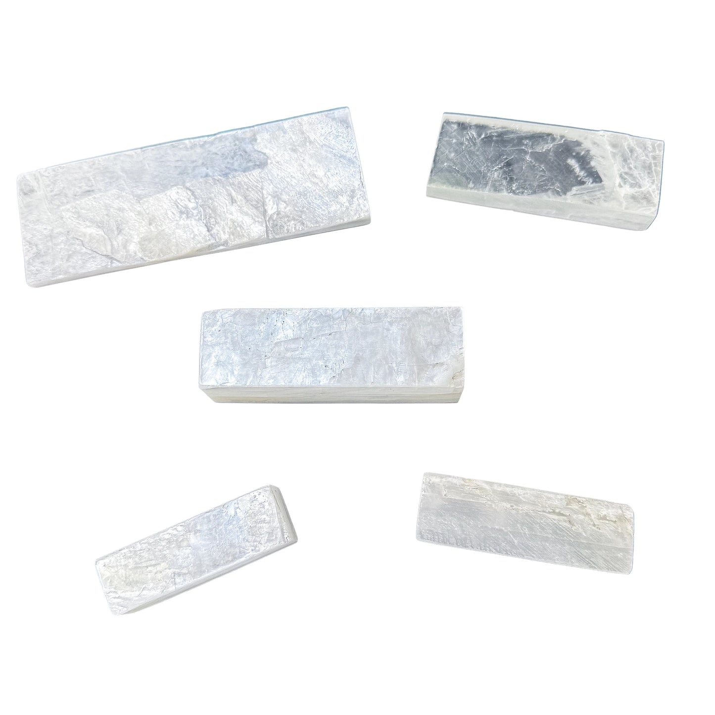 Five Selenite polished sticks laid out to show the range of lengths available