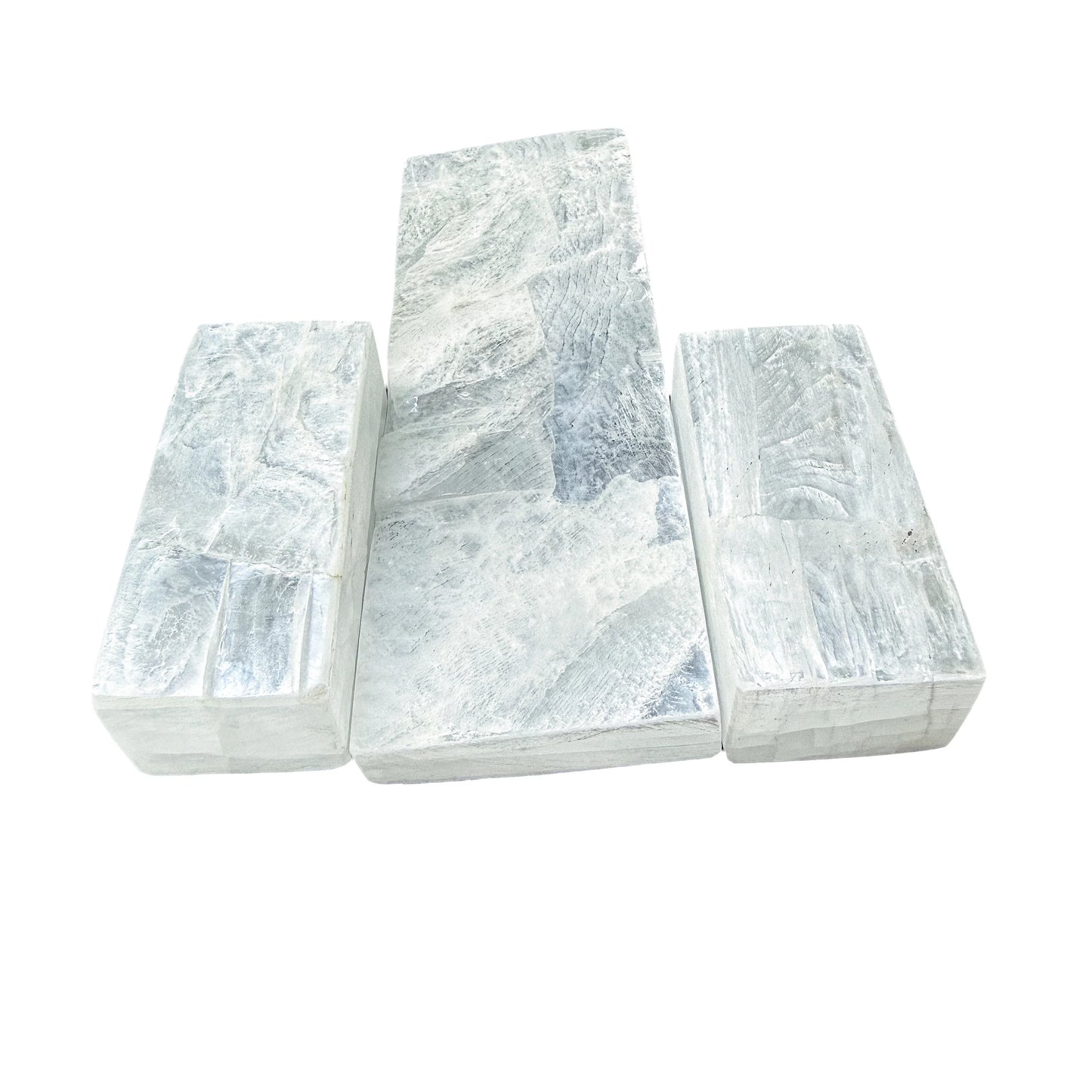 Three Selenite charging sticks arranged in a stepped row by size