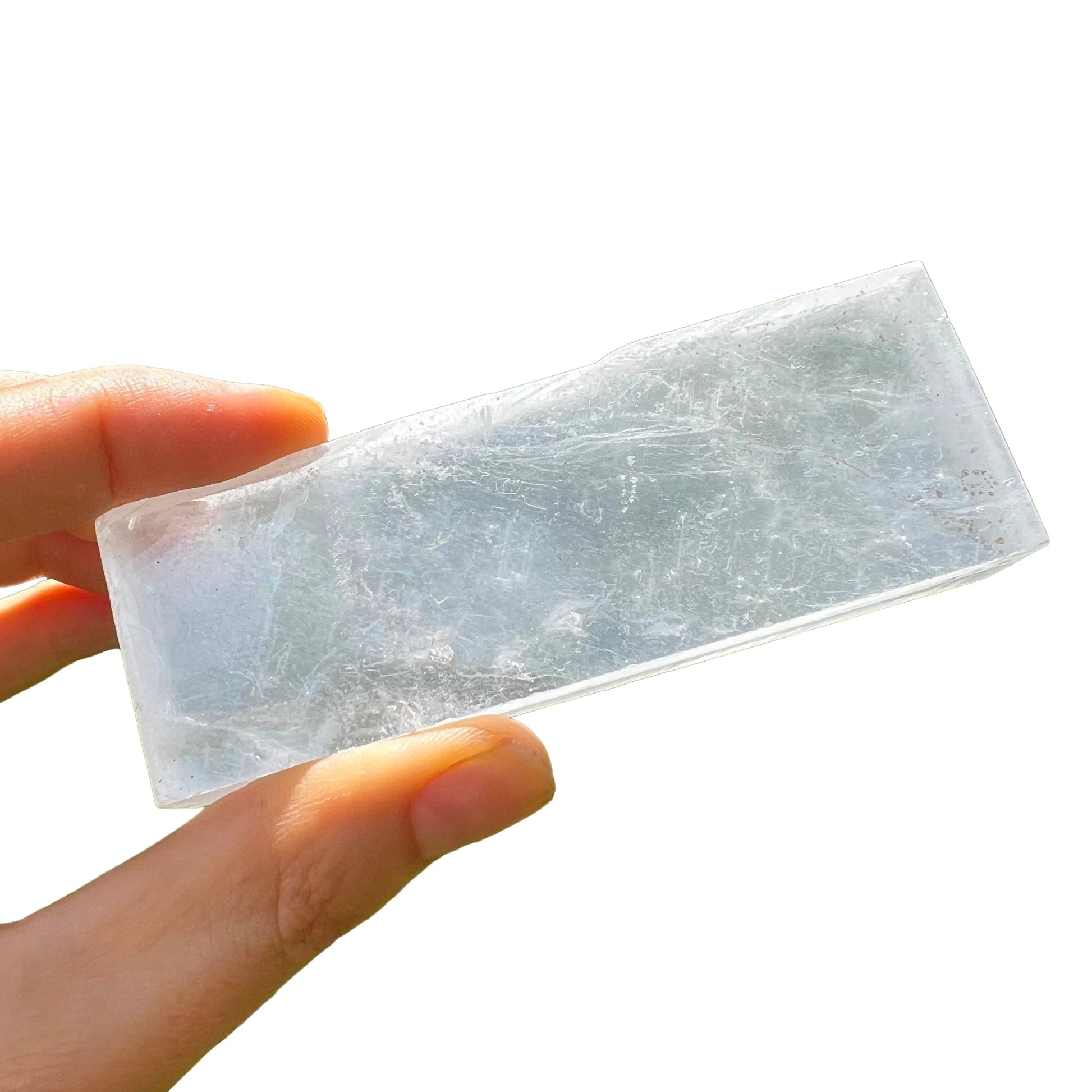 Composed shot of Selenite raw crystal, from New Mexico, USA, shown for proportion against the hand.