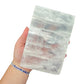 Selenite clearing block from New Mexico held in an open hand, backlit to show translucency, 1.99 pound piece, specimen 66.