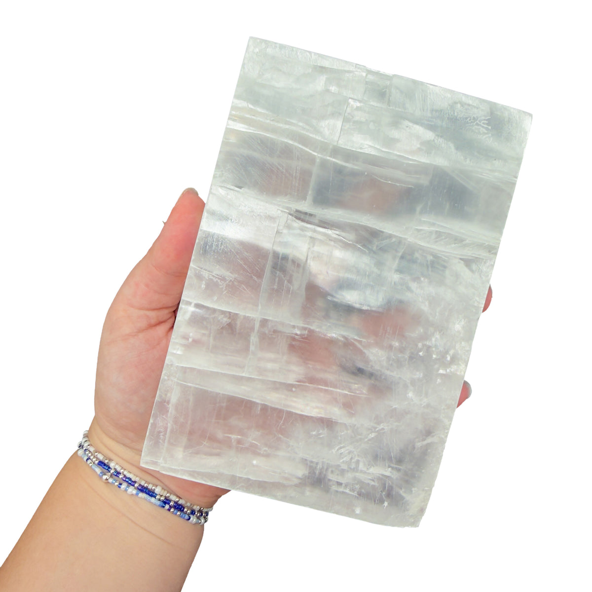Selenite clearing block from New Mexico held in an open hand, backlit to show translucency, 1.99 pound piece, specimen 66.