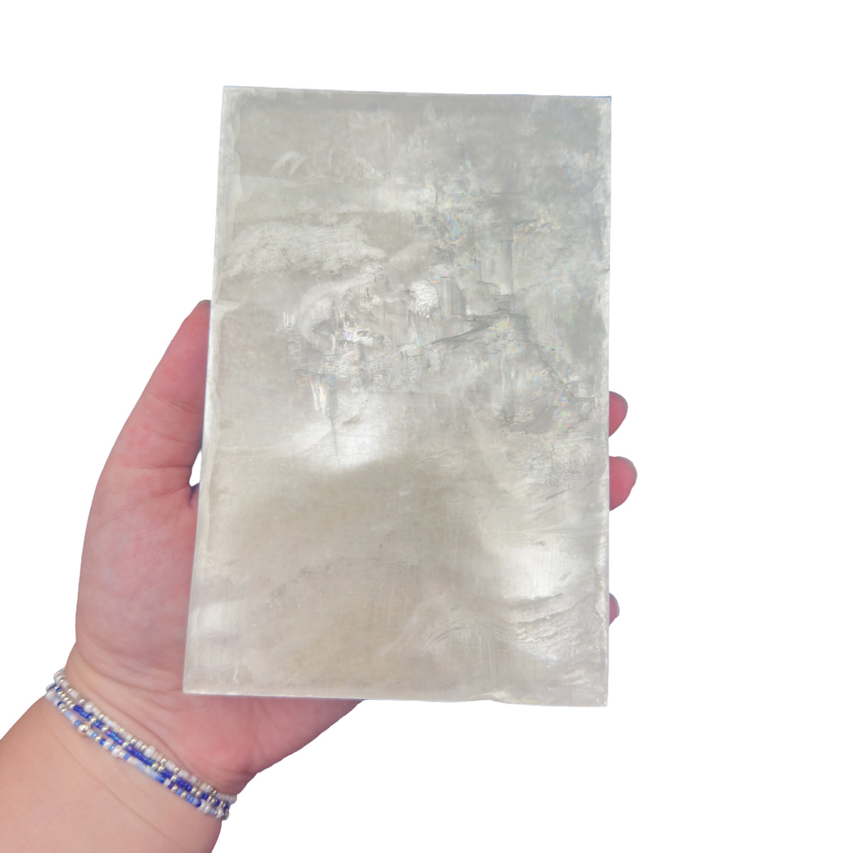 Selenite clearing block from New Mexico held in an open hand, backlit to show translucency, 2.25 pound piece, specimen 67.