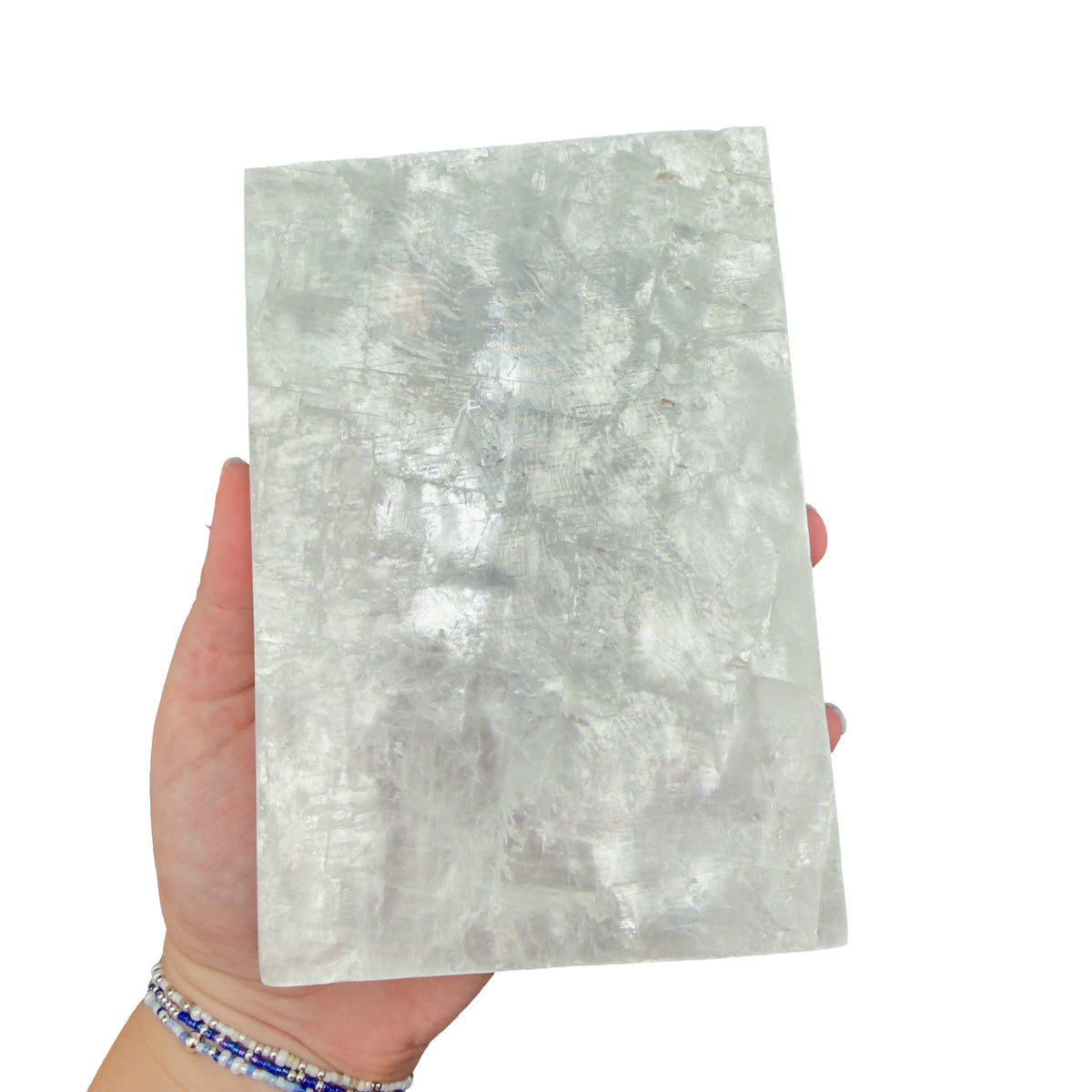 Selenite clearing block from New Mexico held in an open hand, backlit to show translucency, 2.43 pound piece, specimen 68.