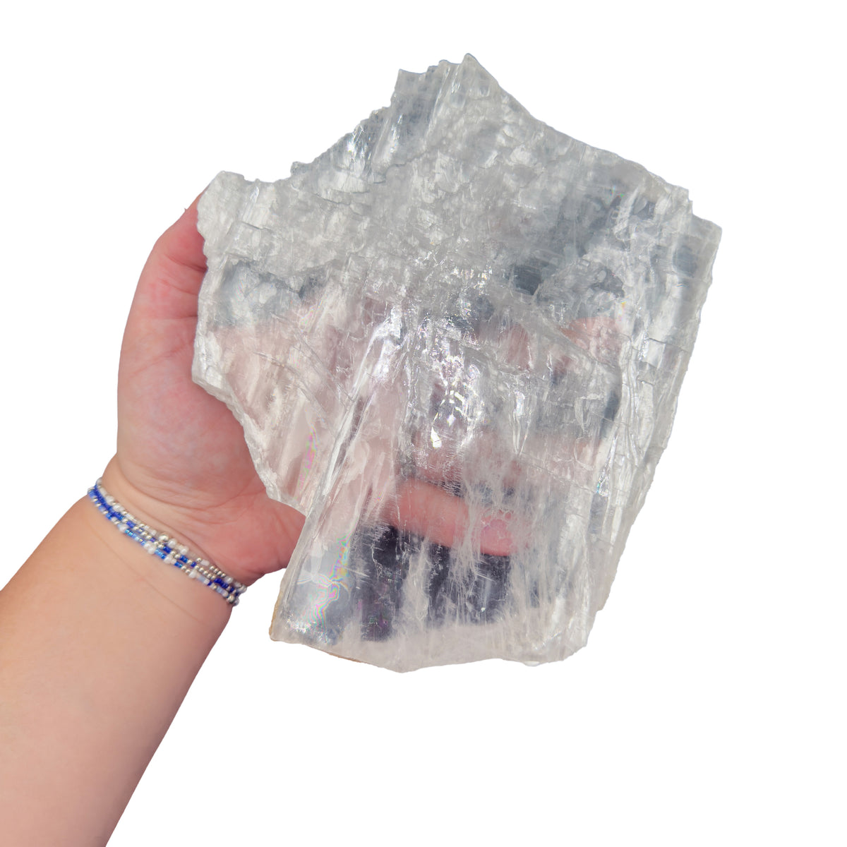 Selenite clearing slab from New Mexico held in an open hand, backlit to show translucency, 1.98 pound piece, specimen 55.