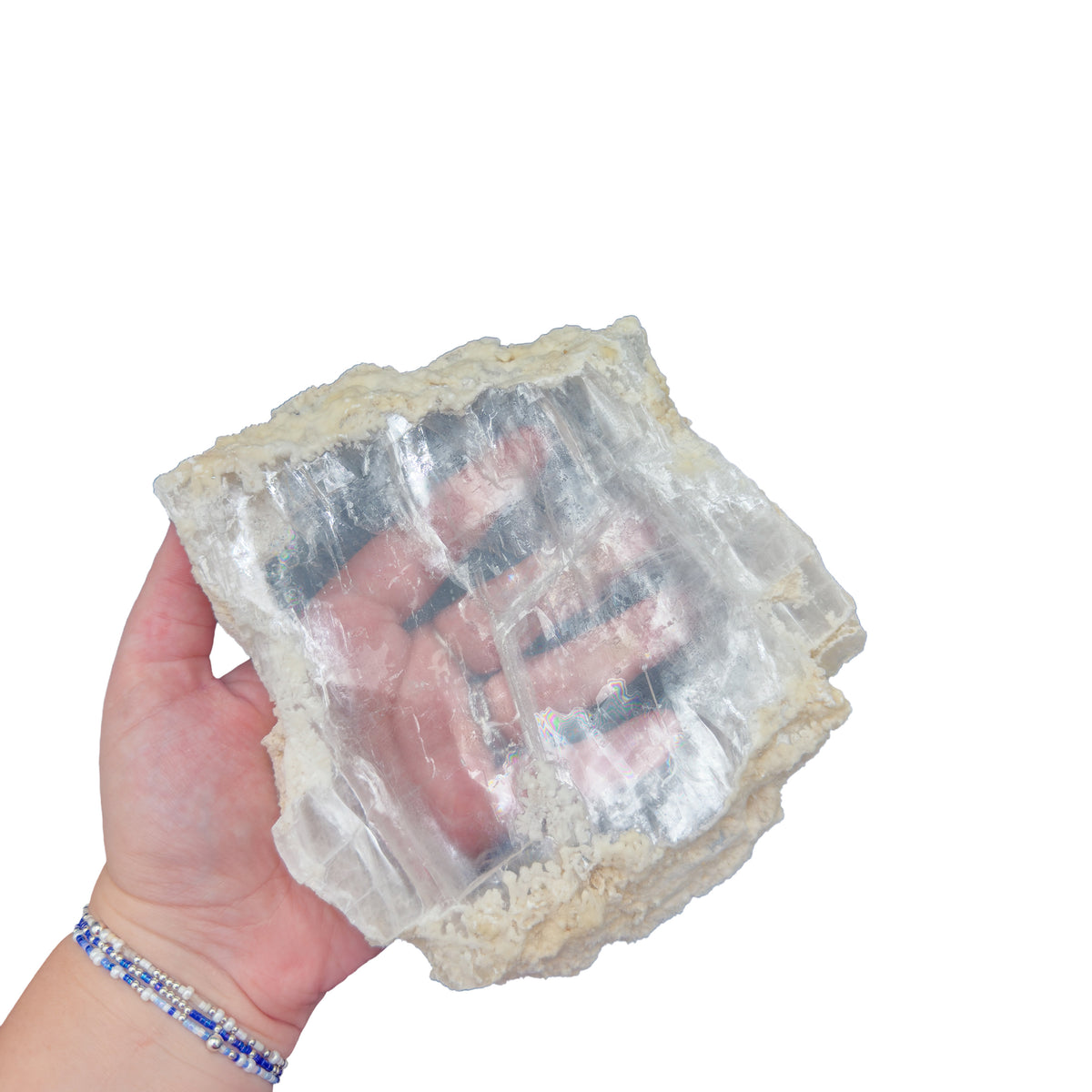 Selenite clearing slab from New Mexico held in an open hand, backlit to show translucency, 1.71 pound piece, specimen 56.