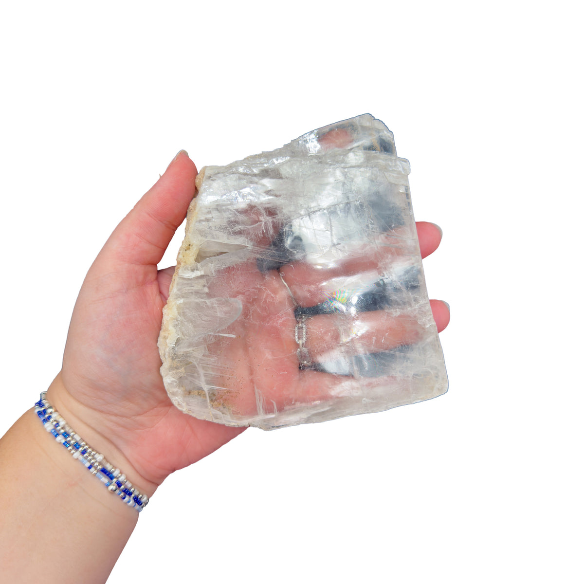 Selenite clearing slab from New Mexico held in an open hand, backlit to show translucency, 0.84 pound piece, specimen 58.