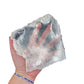 Selenite clearing slab from New Mexico held in an open hand, backlit to show translucency, 0.70 pound piece, specimen 59.